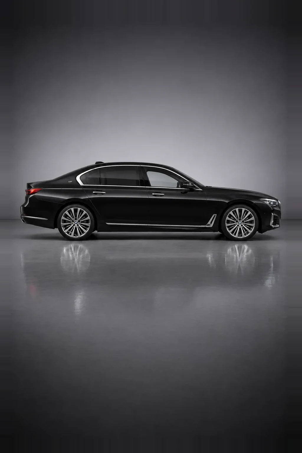 BMW 7 Series executive saloon in black, side profile, studio lit