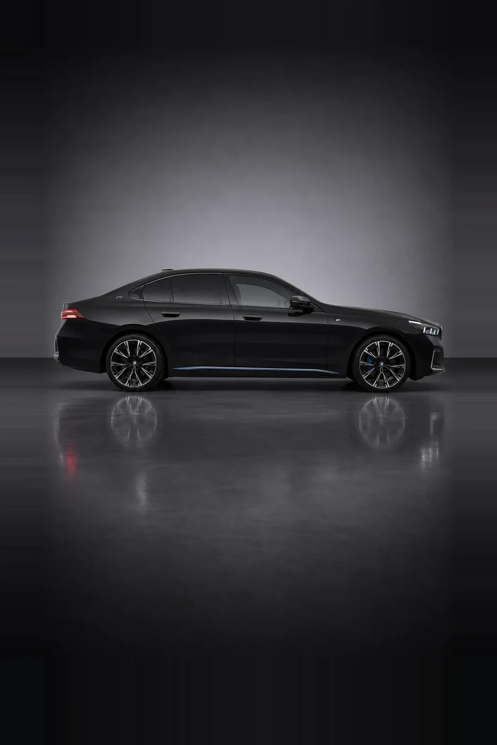 BMW i5 electric executive saloon in black, side profile, studio lit