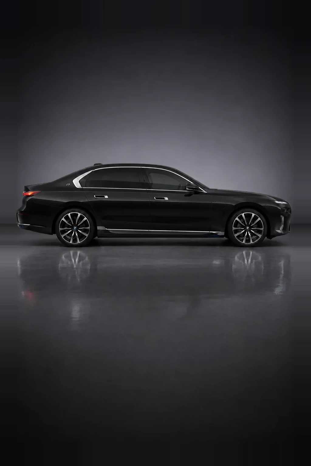 BMW i7 fully electric executive saloon in black, side profile, studio lit