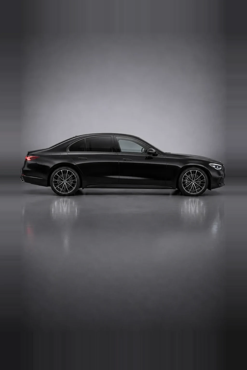 Mercedes-Benz E-Class executive saloon in black, side profile, studio lit